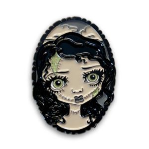 Patchwork Zombie Doll Collectible Enamel Pin - a portrait of a zombie girl in black and grey with green glitter highlights