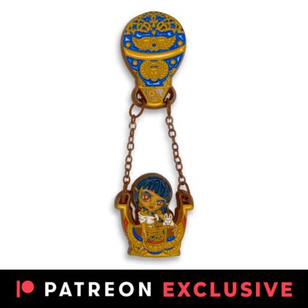Egyptian Chariot enamel pin has an Egyptian queen in a hot air balloon basket with an ornate balloon