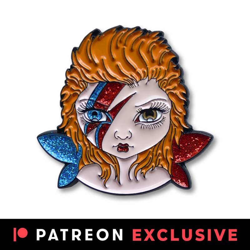 Tiny Bowie fairy pin is an enamel pin of a big eyed fairy with one blue eye, one brown eye, blue and red sparkly wings and red and blue lightening bolt on its face